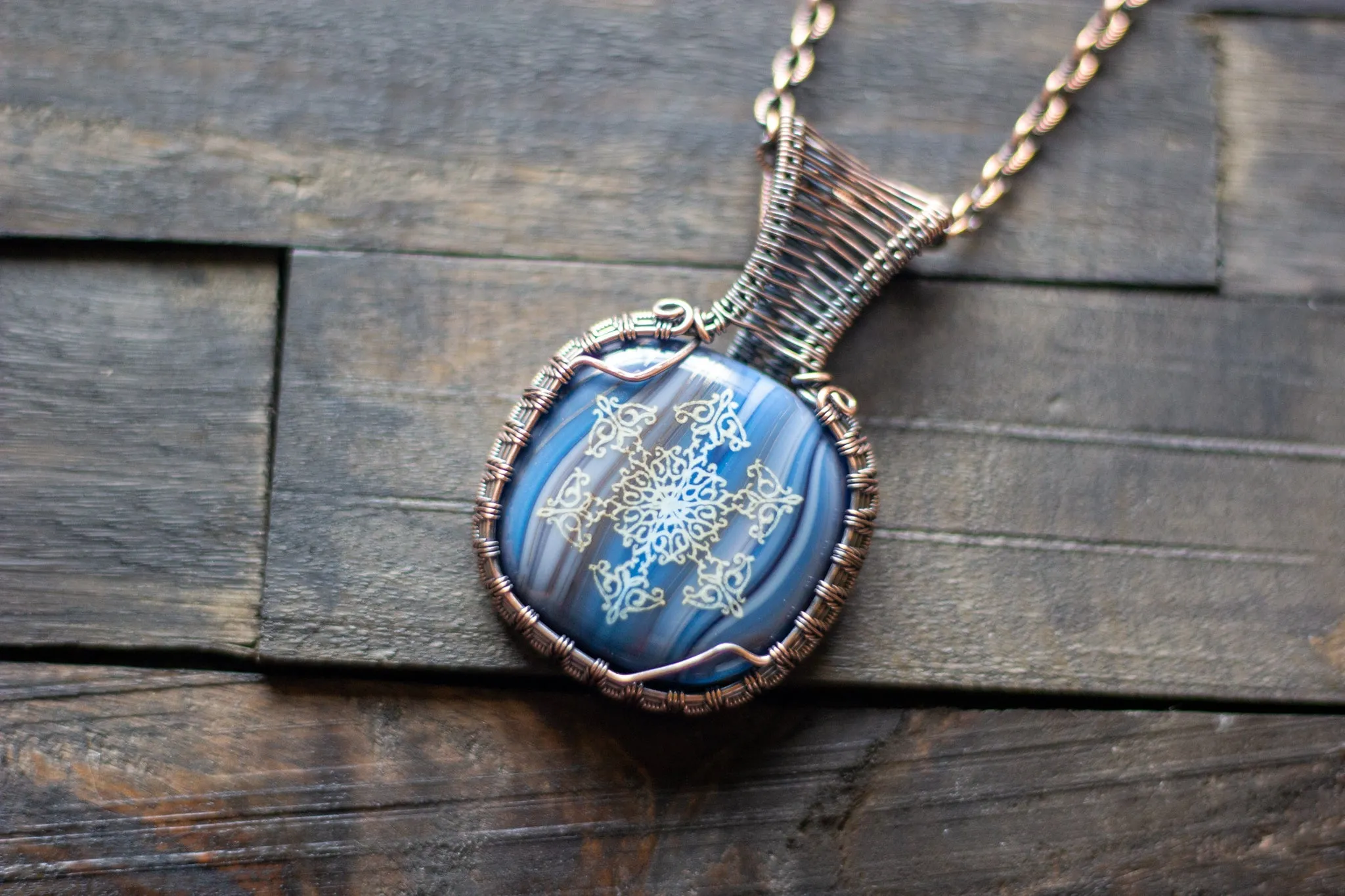 Copper Wire Wrapped Pendant with Snowflake on Streaked Blue Fused Glass