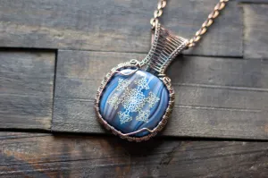 Copper Wire Wrapped Pendant with Snowflake on Streaked Blue Fused Glass