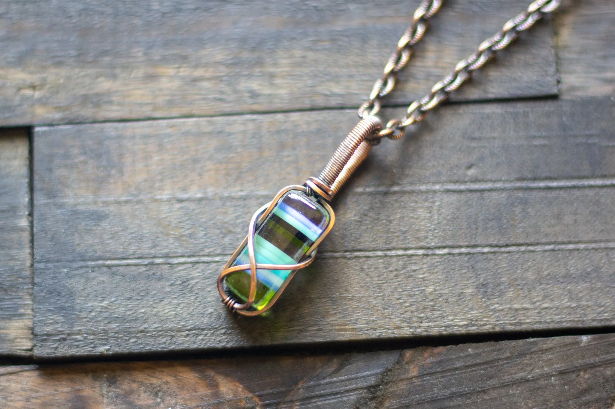 Streaked Green and Blue Fused Glass and Copper Wire Crisscross Pendant